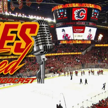 Calgary Flames hockey game action inside the arena with fans.