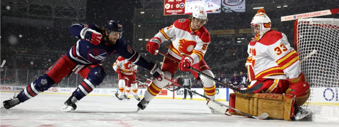 Ice hockey players in action during a fast-paced game on an outdoor rink.