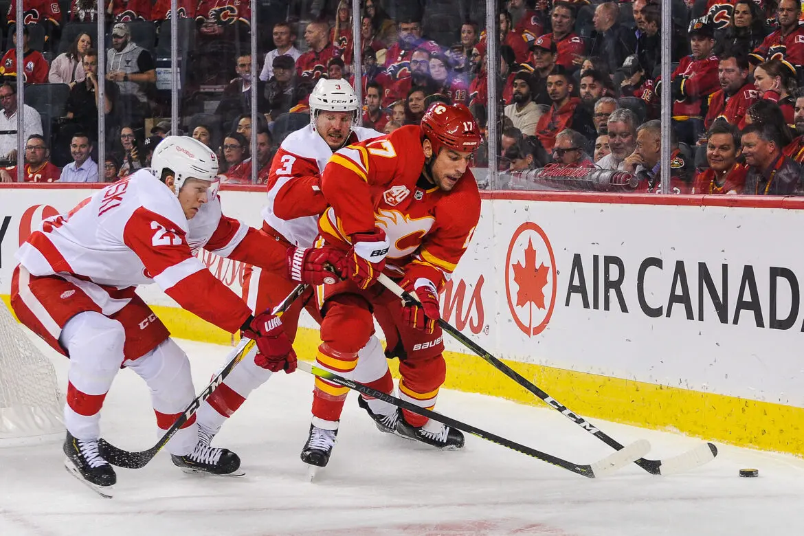 Two ice hockey players competing for the puck during a game.