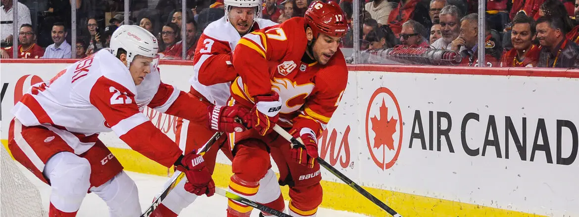 Two hockey players competing aggressively on the ice rink.