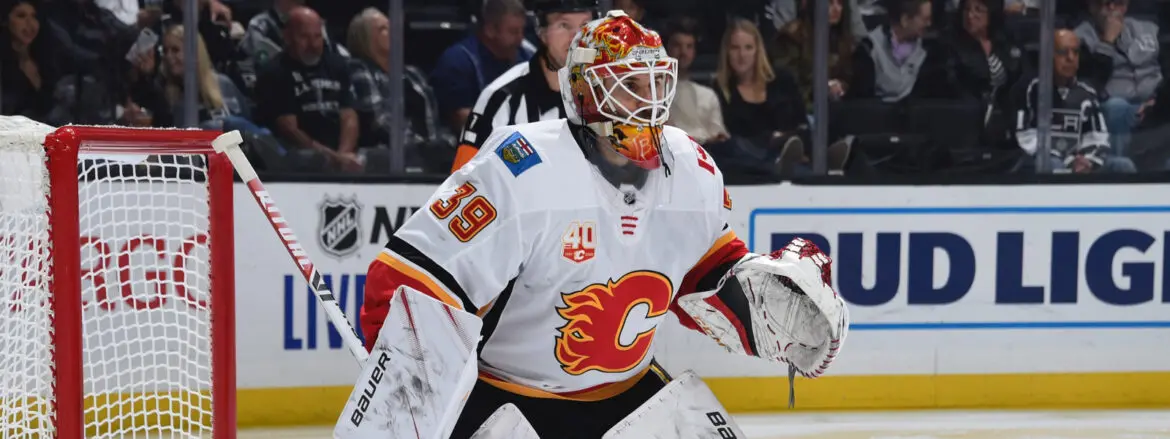 Calgary Flames goalie in full gear during a hockey game.