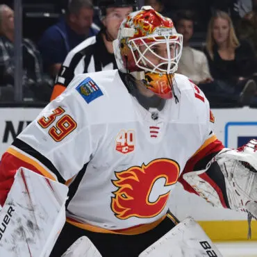 Calgary Flames goalie in full gear during a hockey game.