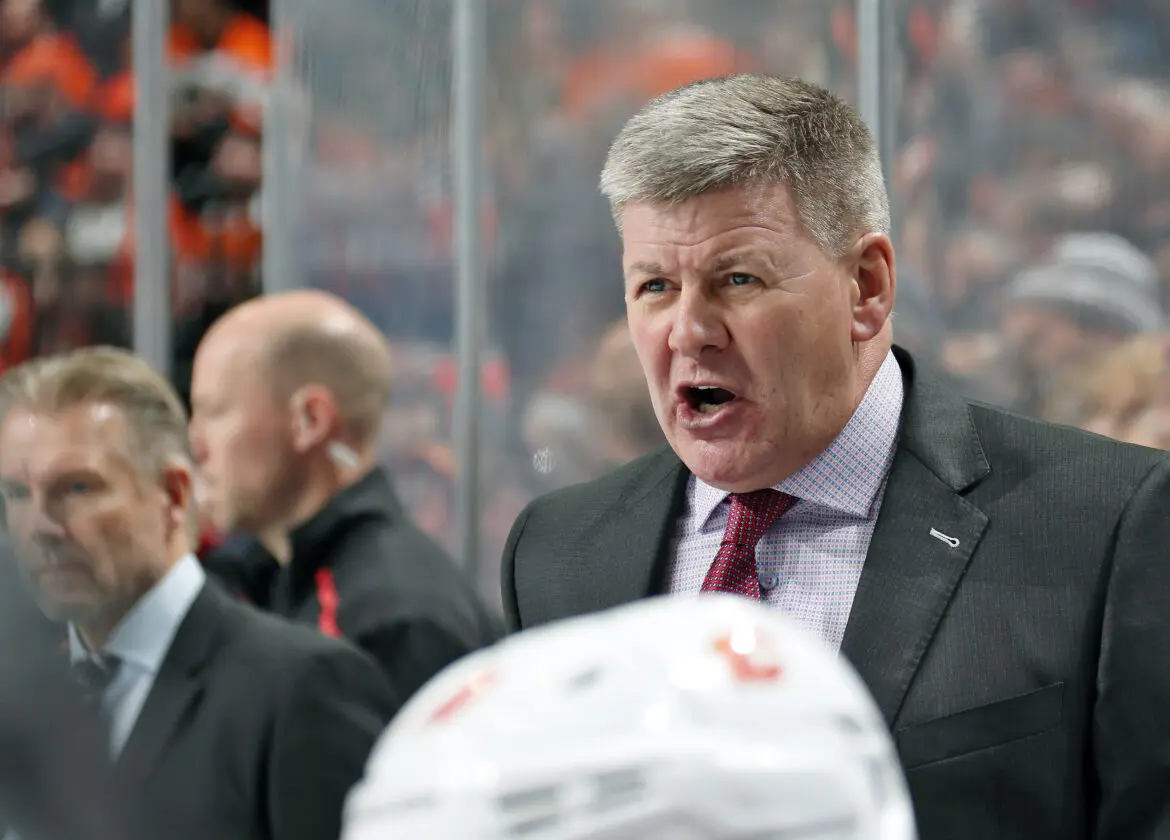 A coach passionately shouting during a hockey game.