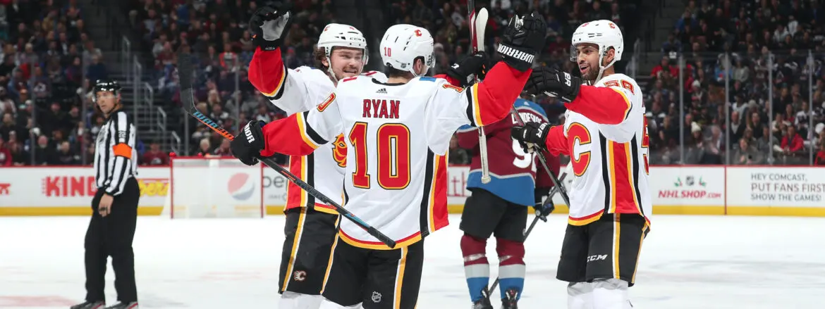 Hockey players celebrating a goal on the ice rink.