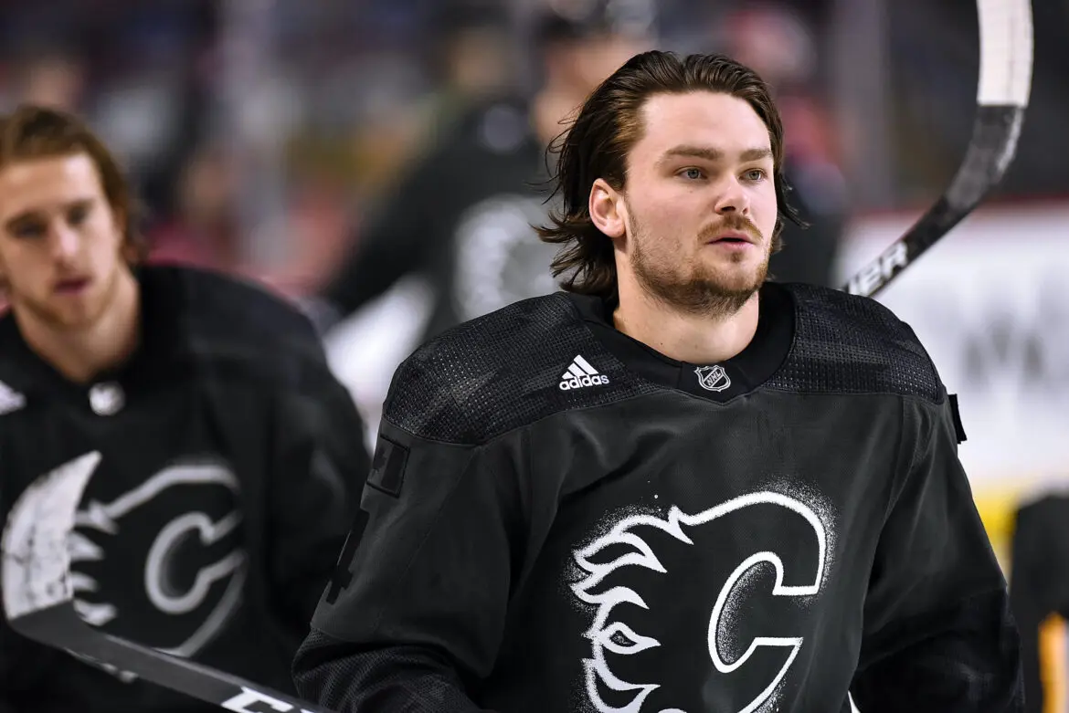 Hockey player in Calgary Flames jersey on the ice.