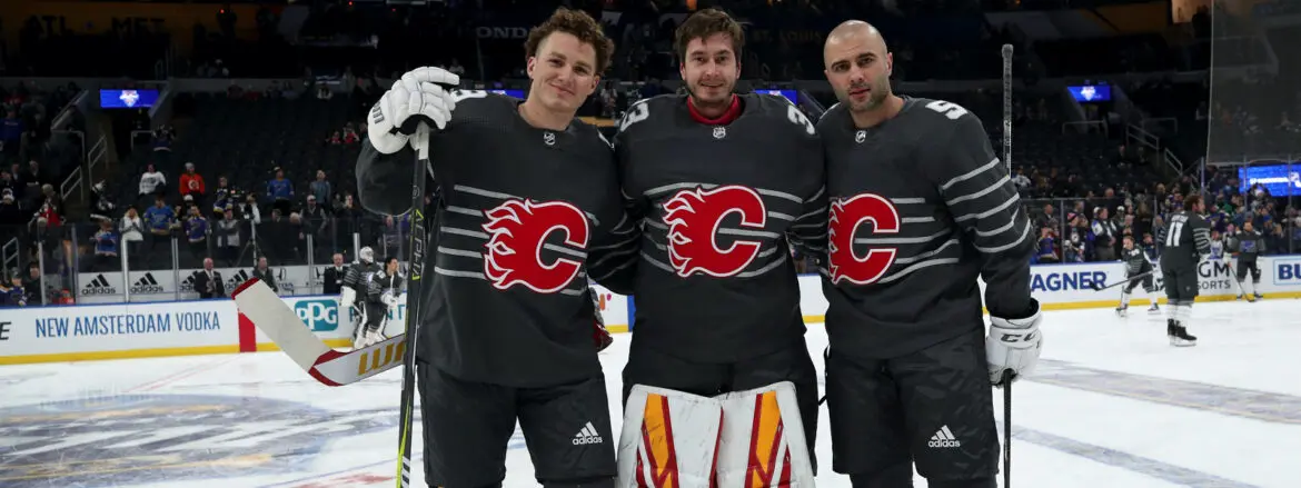 Three hockey players posing together in Calgary Flames jerseys.