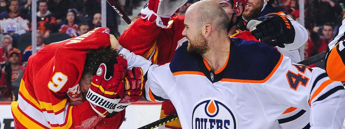 Hockey player in Edmonton Oilers uniform fist-bumping a teammate.