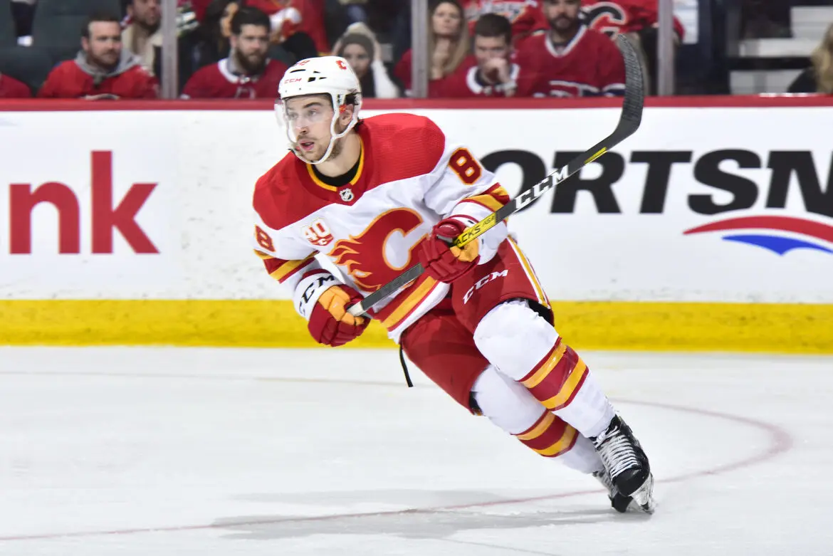 Hockey player in Calgary Flames gear skating on ice during a game.