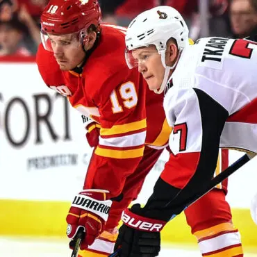 Two ice hockey players in action during a game.