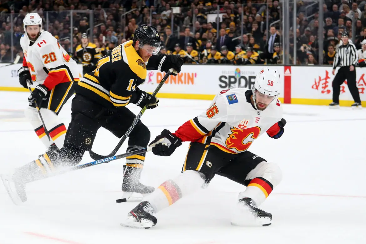 Two ice hockey players competing intensely during a game.