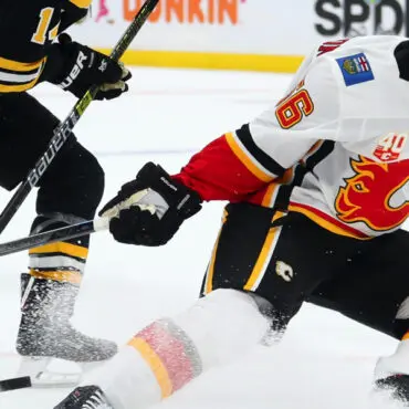 Two ice hockey players competing on the ice rink.