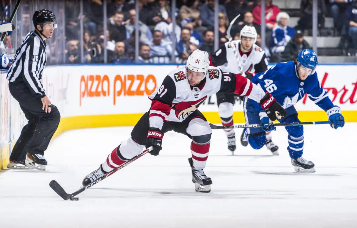 Ice hockey players competing intensely during a game on the rink.