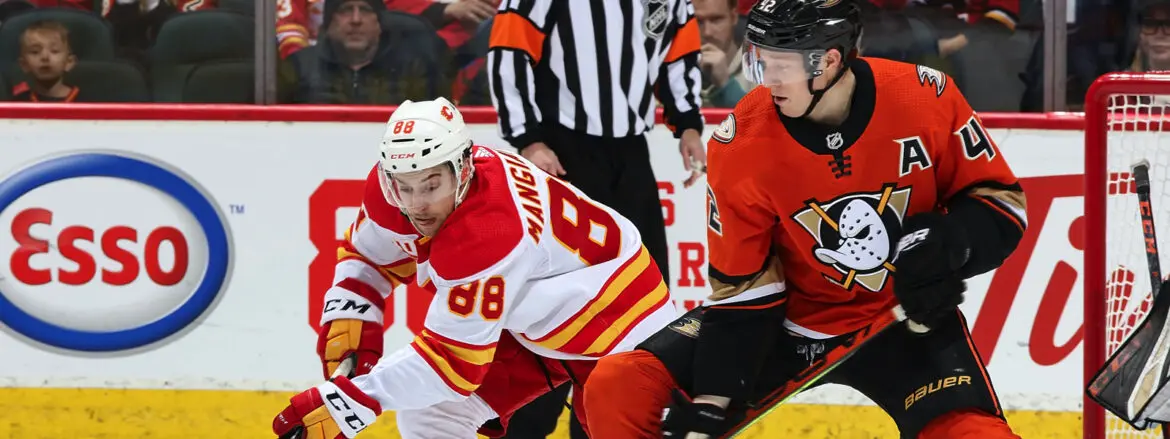 Two ice hockey players competing intensely on the rink.