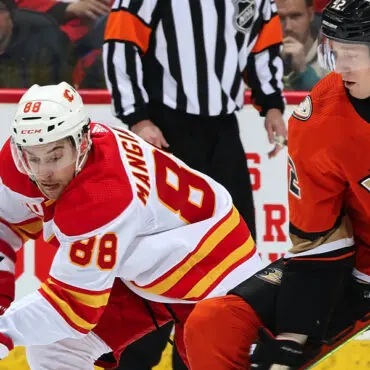 Two ice hockey players competing intensely on the rink.
