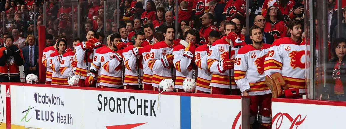 Calgary Flames hockey players stand for the anthem before a game.