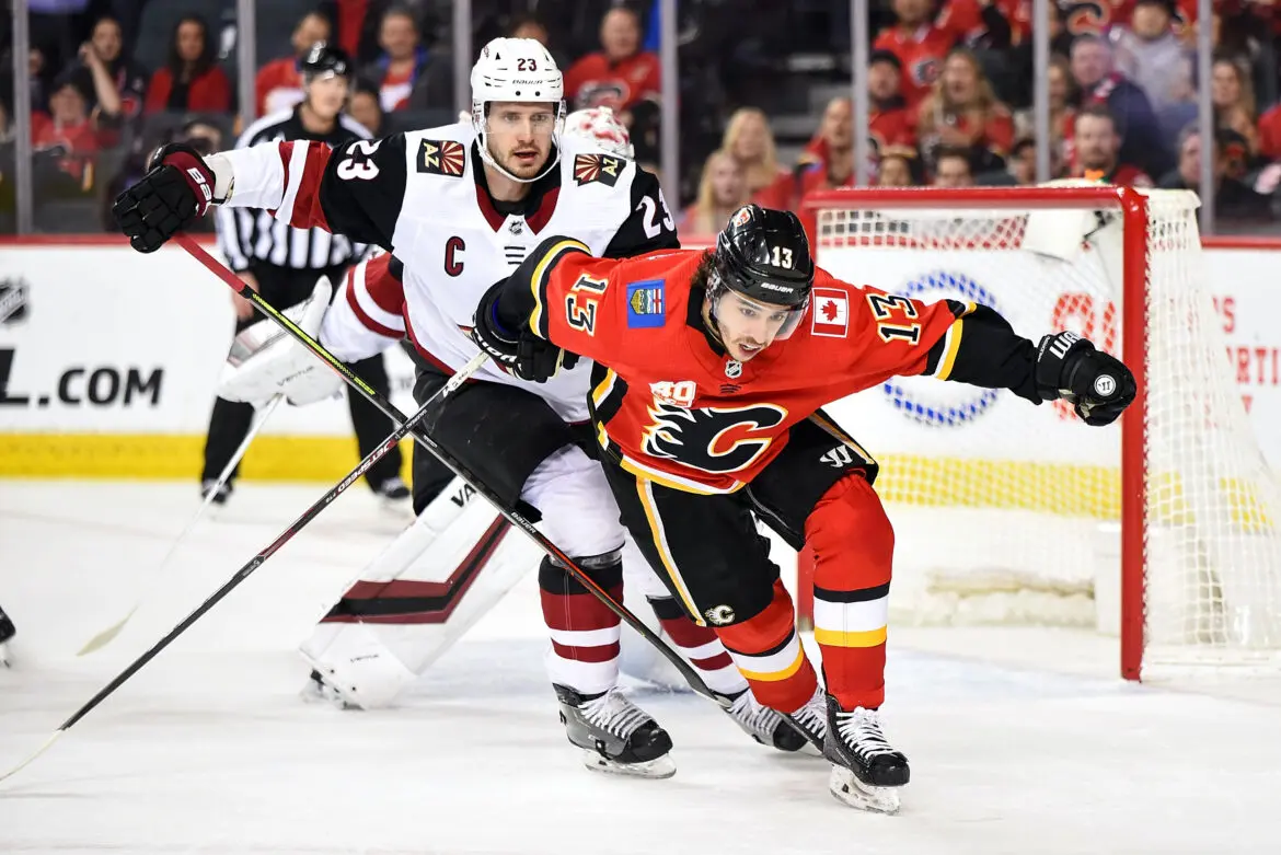 Two hockey players competing intensely on the ice during a game.