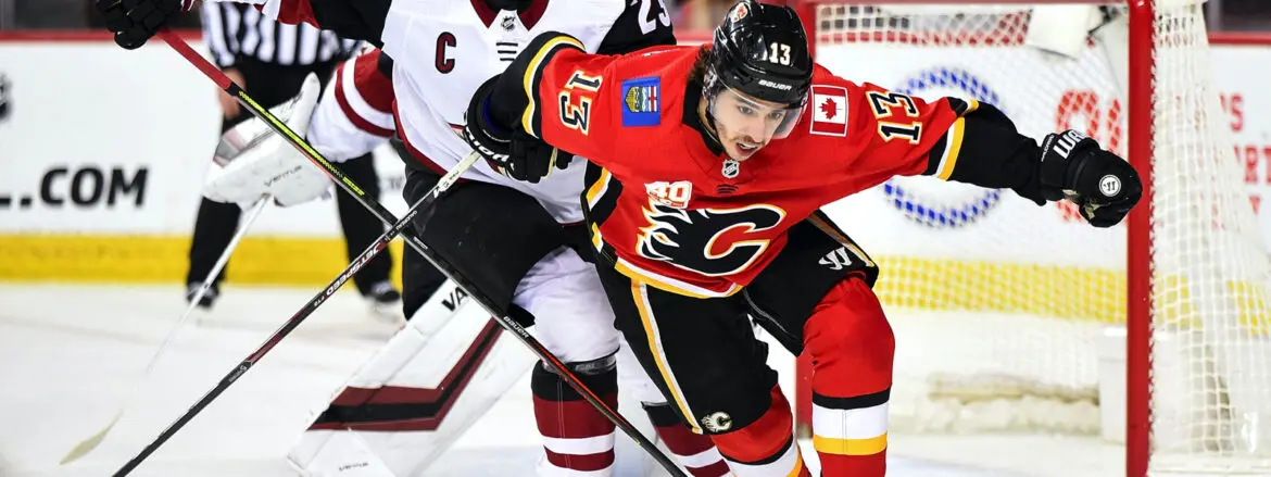 Hockey players from Calgary Flames and Arizona Coyotes compete intensely.