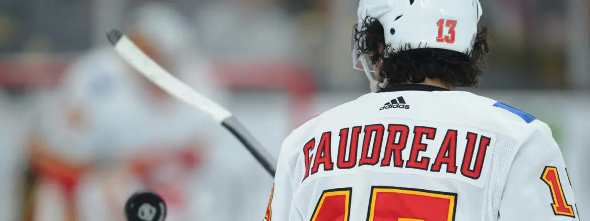 Close-up of a hockey player named Saudreau in white gear on the ice.