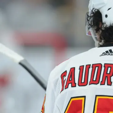 Close-up of a hockey player named Saudreau in white gear on the ice.