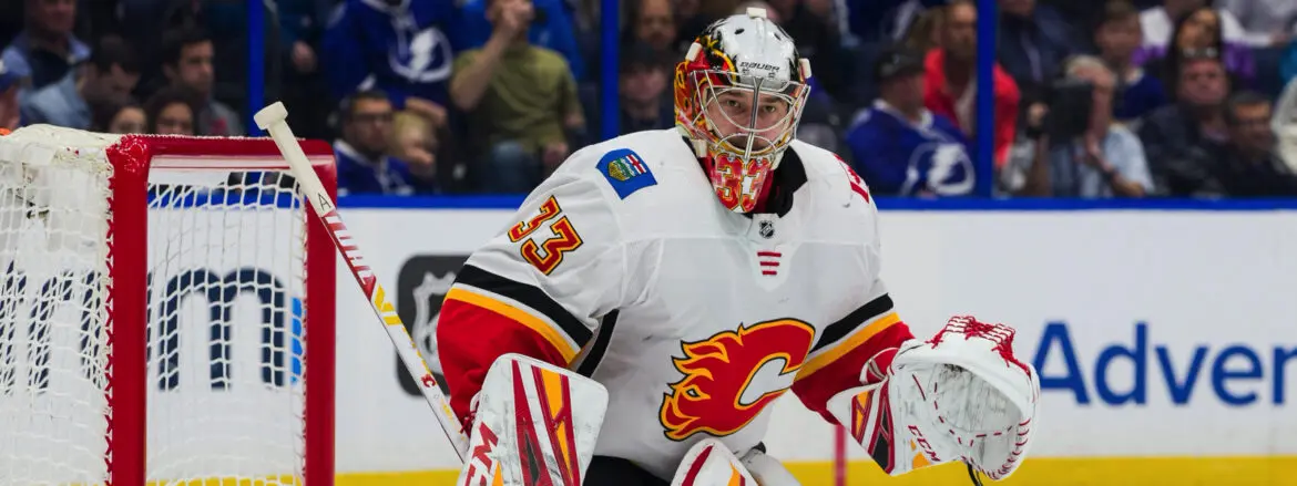 Calgary Flames goalie in action during a hockey game.