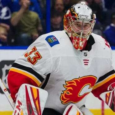 Calgary Flames goalie in action during a hockey game.