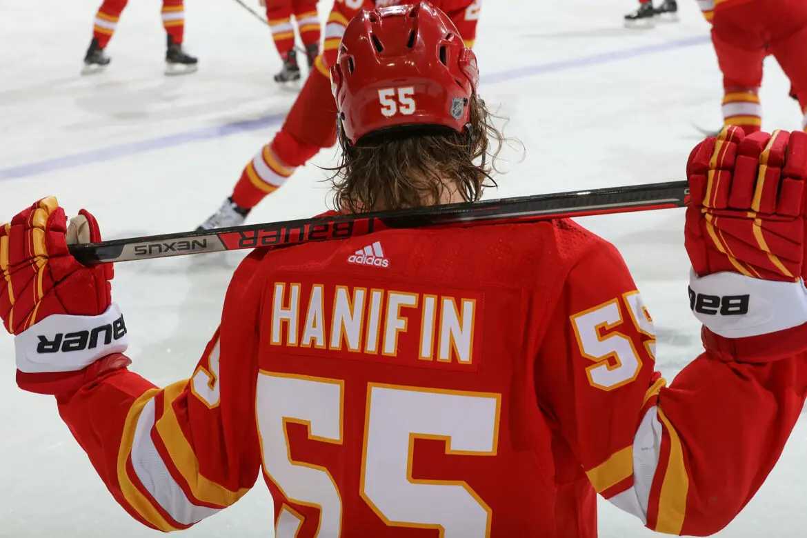 Hockey player Hanifin wearing jersey number 55 on the ice.
