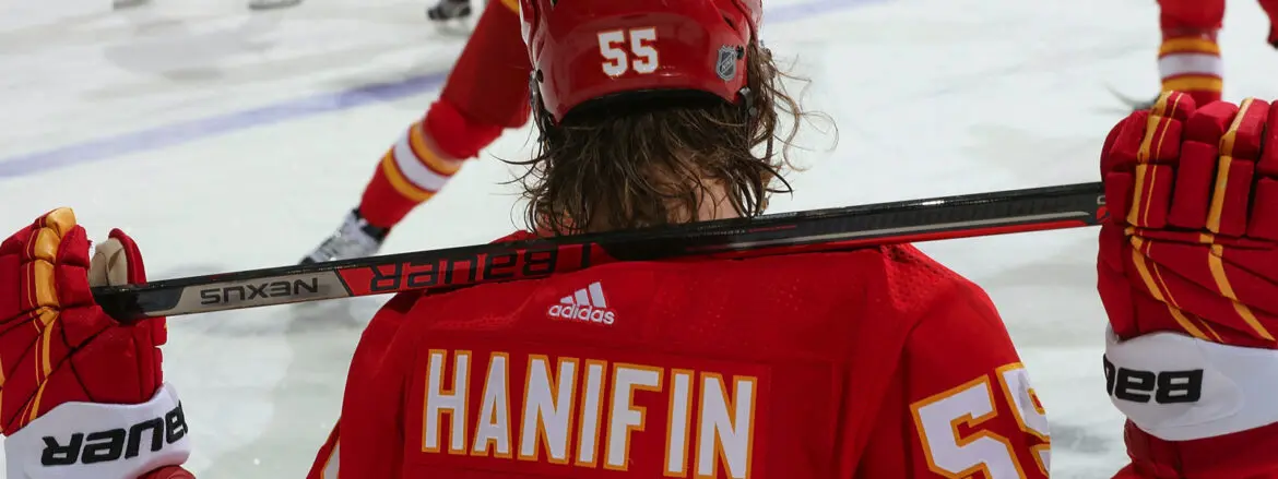 Close-up of a hockey player wearing a red jersey with "Hanifin" and number 55.