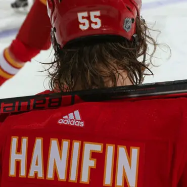 Close-up of a hockey player wearing a red jersey with "Hanifin" and number 55.