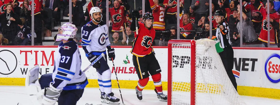 Calgary Flames player celebrates goal against Vancouver Canucks.