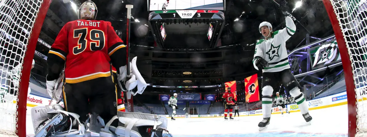 Ice hockey players in action during a game in an arena.