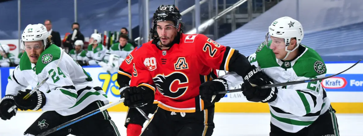 Hockey player in a red Calgary Flames jersey skating on ice.