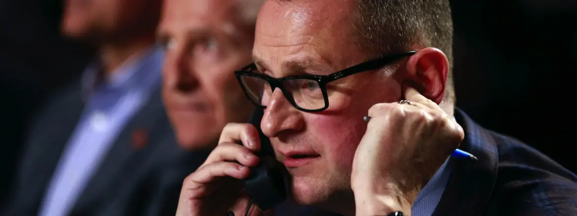 Man wearing glasses talking on the phone.