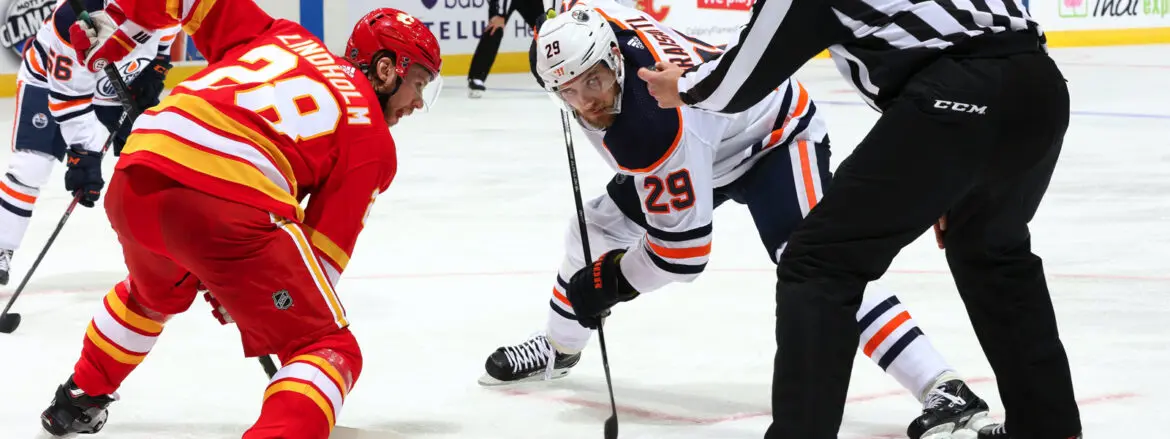 Two hockey players face off during a game.