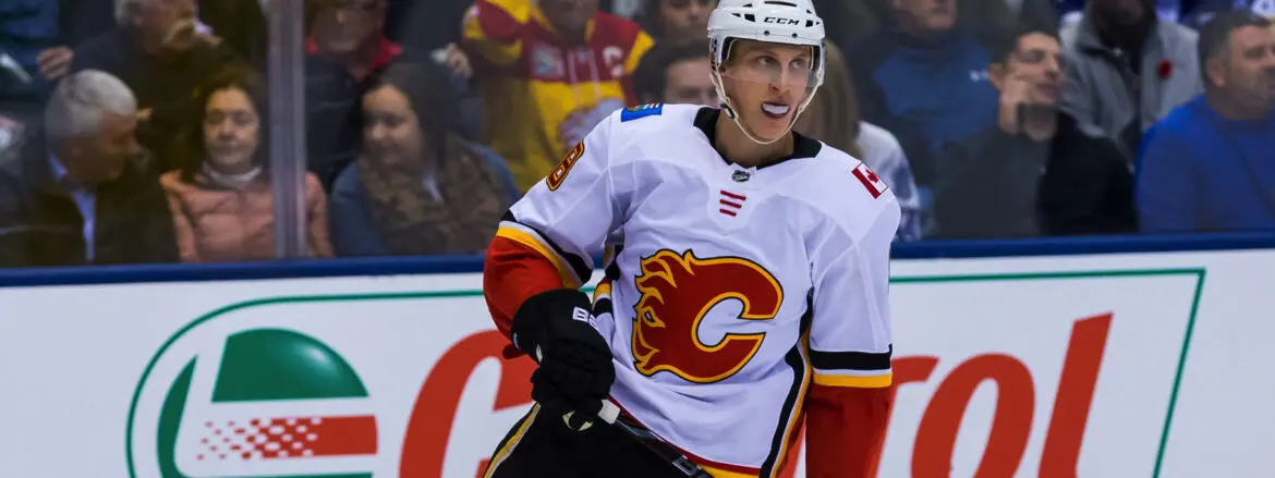 Calgary Flames hockey player in white jersey during a game.