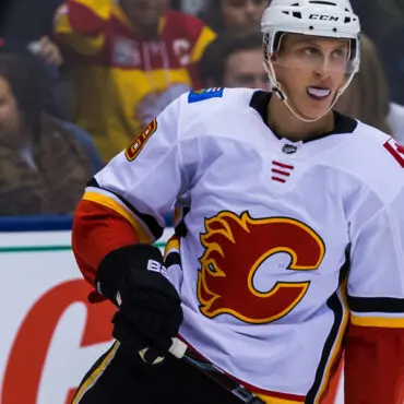 Calgary Flames hockey player in white jersey during a game.