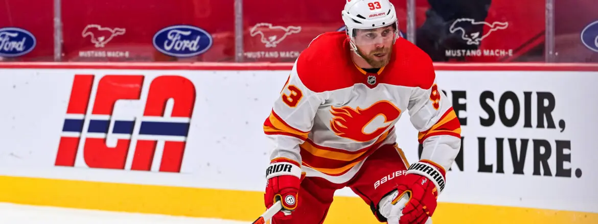 Calgary Flames player in red and white gear during a hockey game.