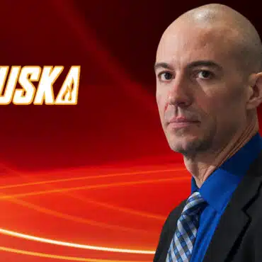 Professional man in suit with red abstract background and text.