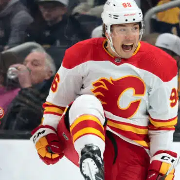 A Calgary Flames hockey player celebrating on the ice.