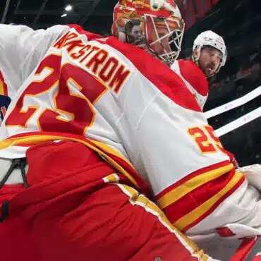 Hockey goalie making a save during a game.