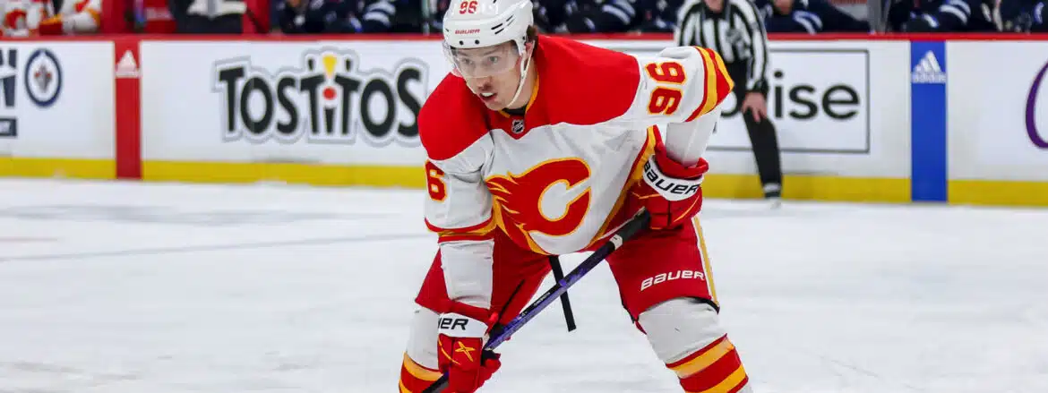 Hockey player in red and white Calgary Flames uniform on ice.