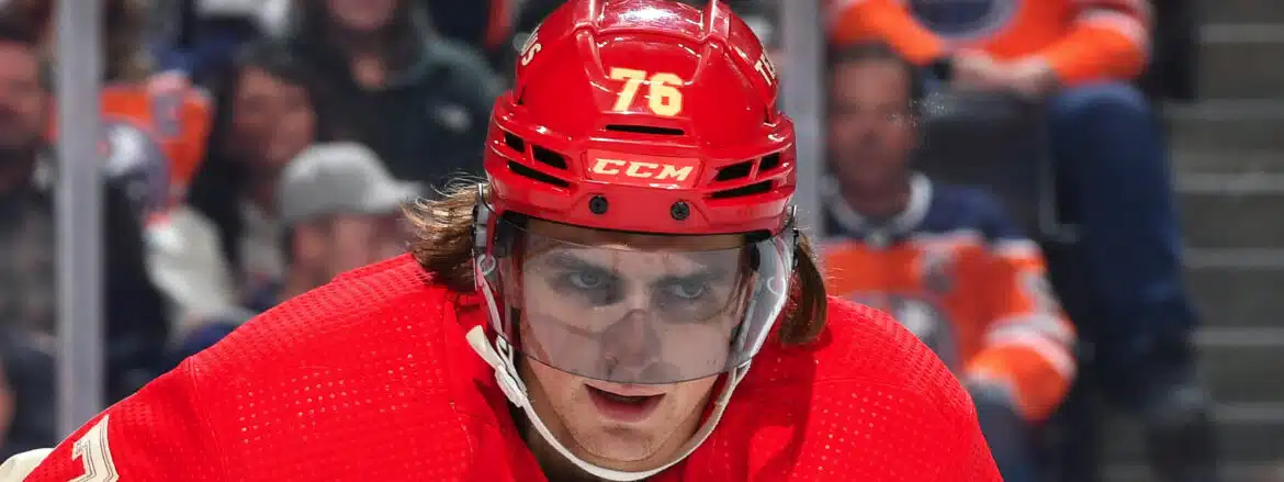Close-up of a hockey player wearing a red helmet with number 76.