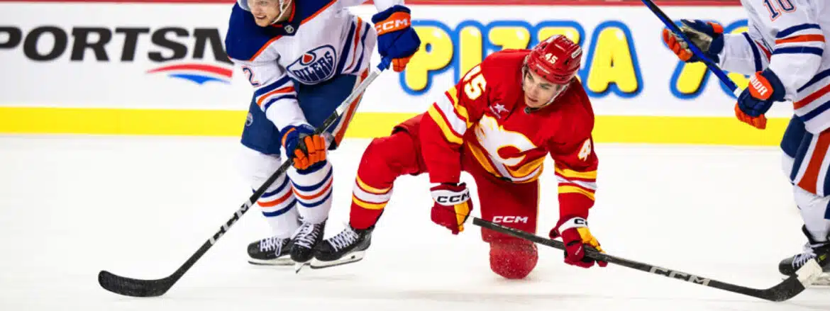 Two hockey players competing intensely on the ice rink.