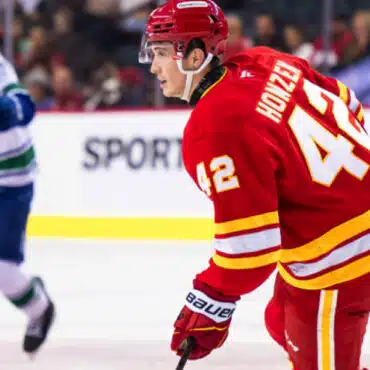 Hockey player in red jersey on ice during a game.