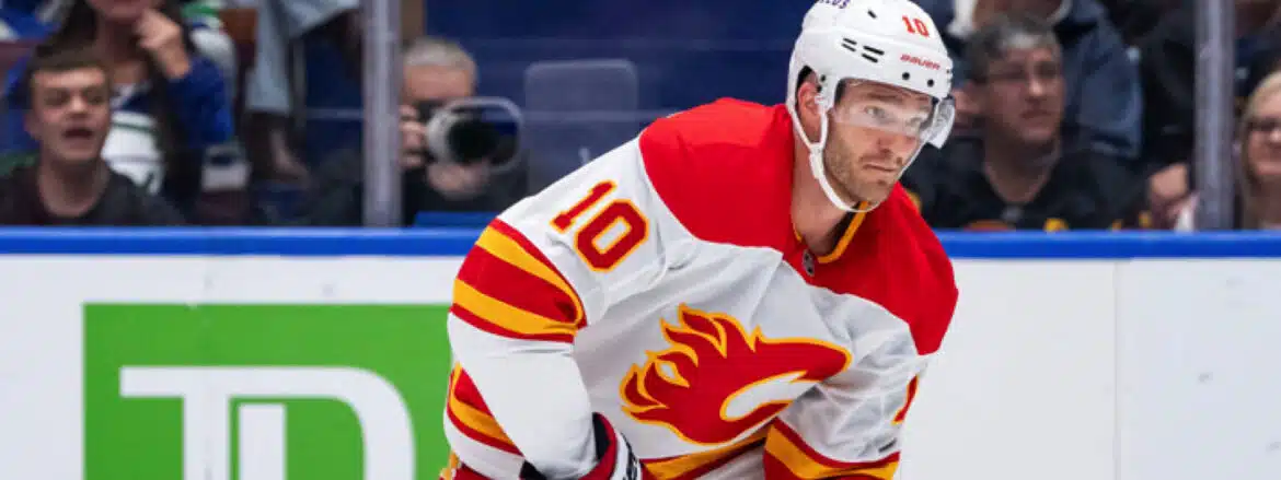 Hockey player in Calgary Flames jersey focused during a game.