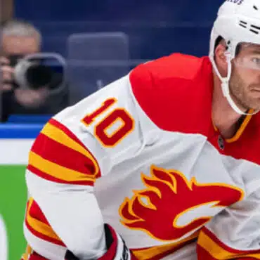 Hockey player in Calgary Flames jersey focused during a game.