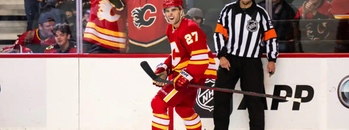 Hockey player in red Calgary Flames uniform on ice.