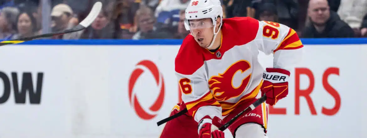 Ice hockey player in Calgary Flames uniform skating during a game.