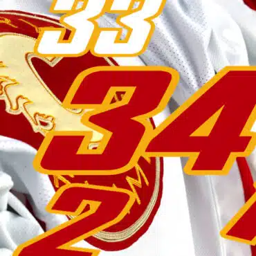 Close-up of a sports jersey with the number 34 and a Trojan helmet logo.