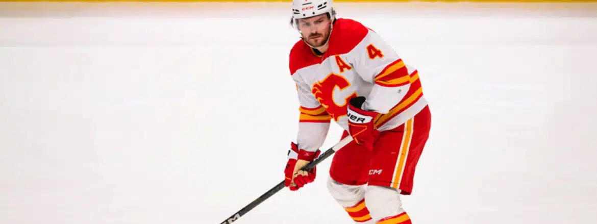 Hockey player in red and white Calgary Flames uniform on ice.