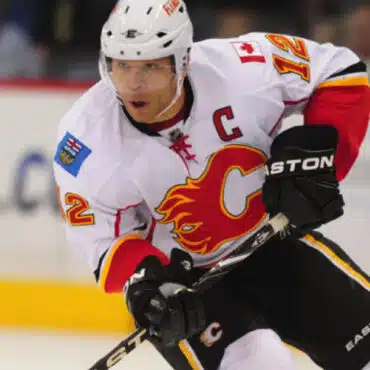 A Calgary Flames hockey player in action on the ice.